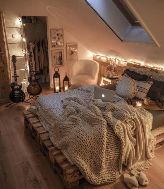 modern boho bedroom with pallet bed and fairy lights